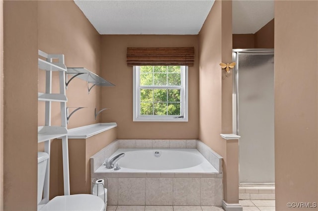 full bathroom featuring toilet, tile patterned floors, a shower stall, and a bath