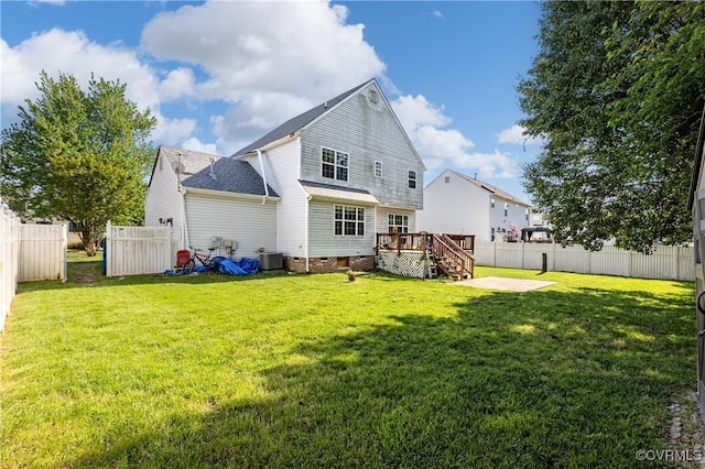 back of house with crawl space, a deck, a patio area, a fenced backyard, and a yard