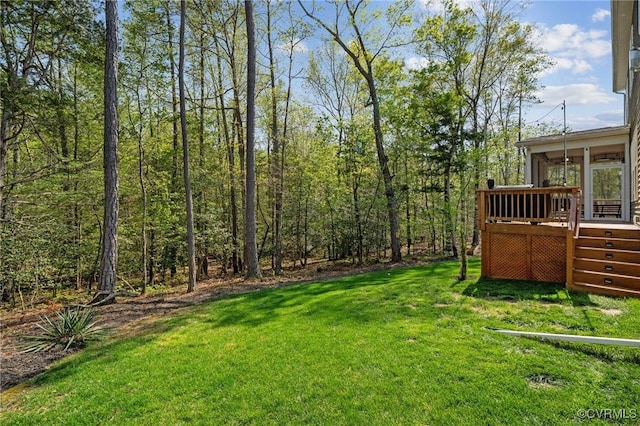 view of yard featuring a wooden deck and a sunroom