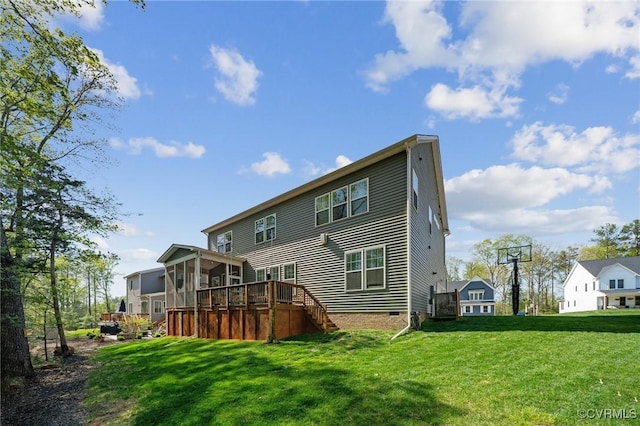 rear view of property with a sunroom, crawl space, a deck, a lawn, and stairway