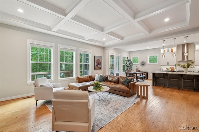 living room with light wood finished floors, coffered ceiling, and beamed ceiling