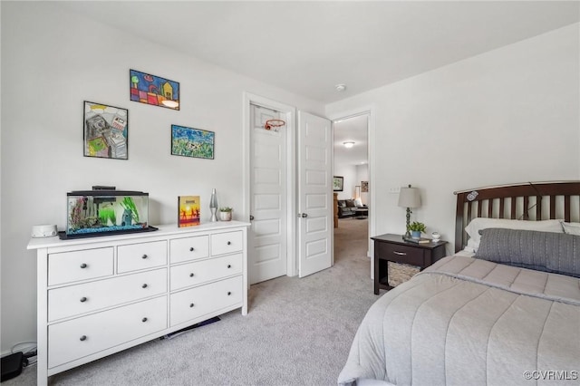 bedroom featuring light carpet