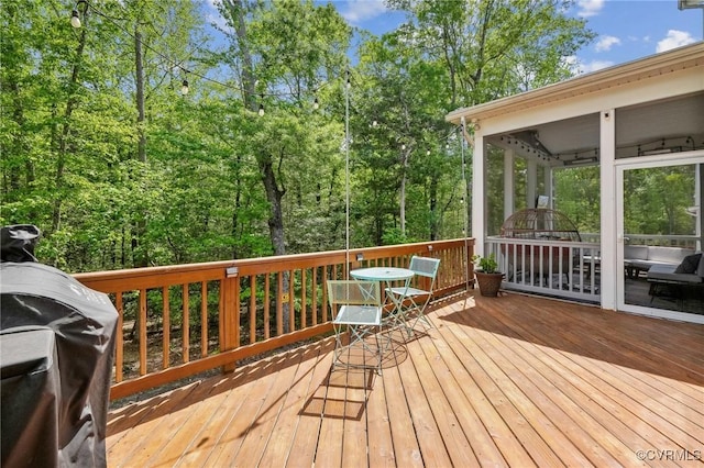 wooden terrace featuring outdoor dining area