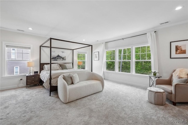 carpeted bedroom featuring multiple windows, visible vents, and baseboards