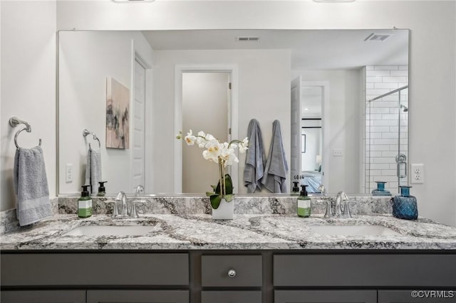 full bathroom with double vanity, visible vents, and a sink