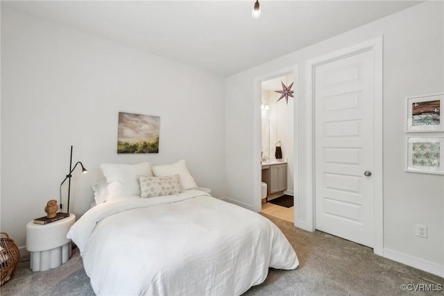 bedroom featuring light colored carpet and connected bathroom