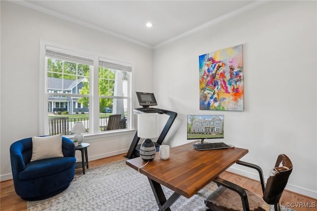 office area with crown molding, wood finished floors, and baseboards