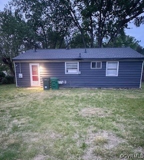 back of property featuring a yard