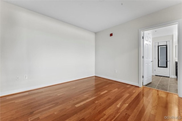 interior space with baseboards and wood finished floors