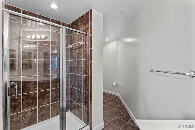 bathroom featuring recessed lighting, a shower stall, tile patterned flooring, and baseboards