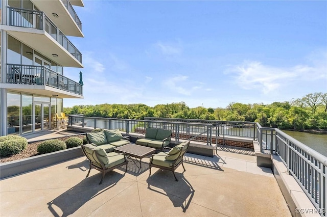 view of patio / terrace with outdoor lounge area and a water view