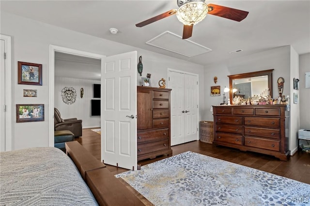 bedroom with visible vents, a closet, attic access, ceiling fan, and dark wood-style floors