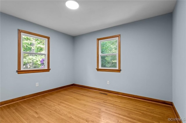 empty room with baseboards and a wealth of natural light