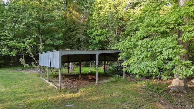 view of yard with a view of trees and a carport