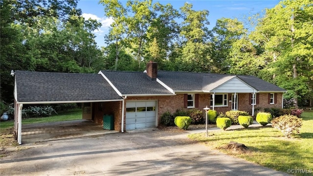 single story home featuring a carport, a chimney, driveway, and brick siding