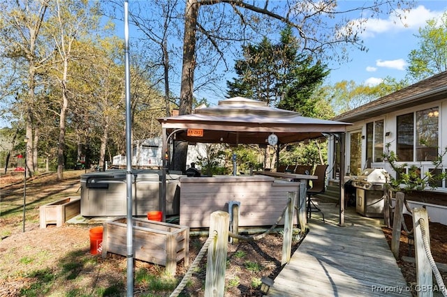 wooden deck with a gazebo, grilling area, a hot tub, and outdoor dry bar
