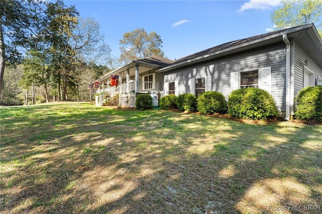 view of home's exterior featuring a yard and covered porch