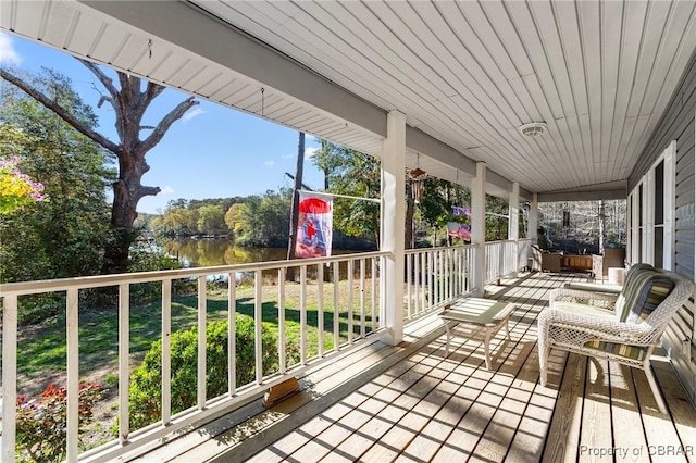 deck featuring a porch and a water view