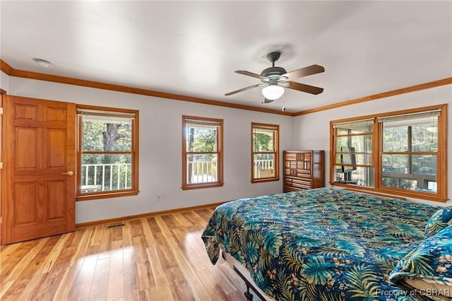 bedroom featuring light wood-type flooring, baseboards, visible vents, a ceiling fan, and crown molding