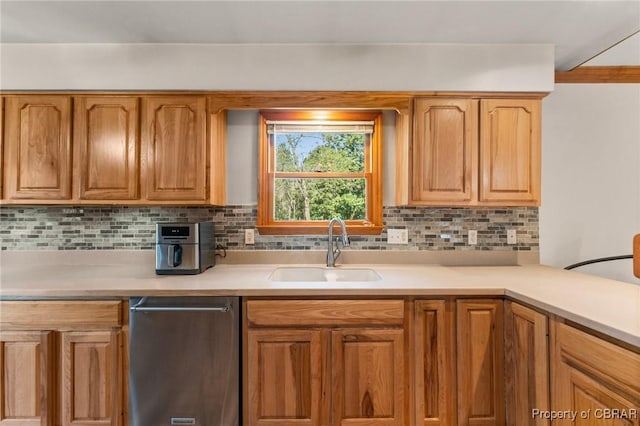 kitchen with dishwasher, tasteful backsplash, a sink, and light countertops