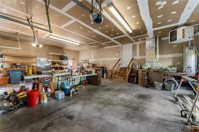 garage with a workshop area, a garage door opener, and gas water heater