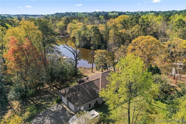 birds eye view of property featuring a view of trees and a water view