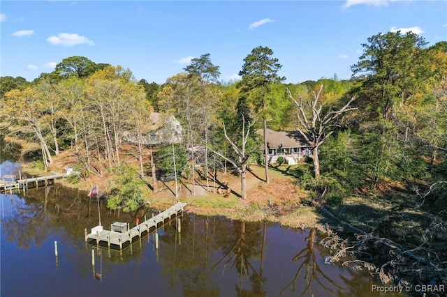 aerial view with a forest view and a water view