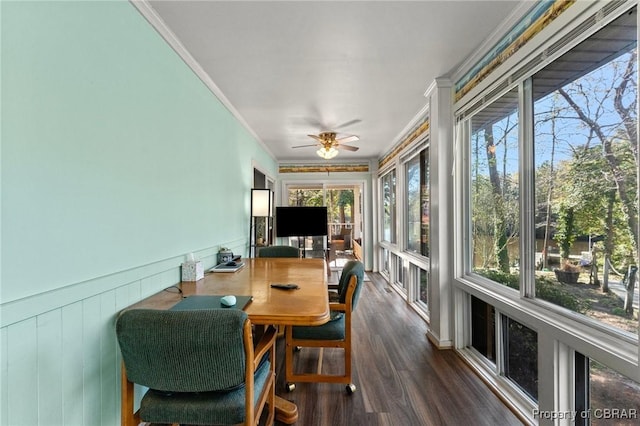sunroom / solarium with wainscoting, crown molding, and wood finished floors