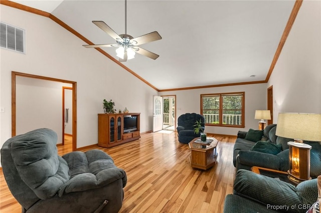 living room featuring lofted ceiling, ornamental molding, visible vents, and light wood-type flooring