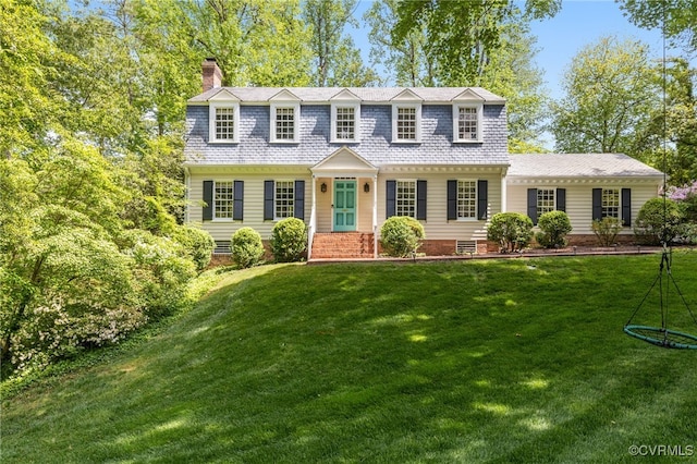 view of front of house with a front lawn and a chimney