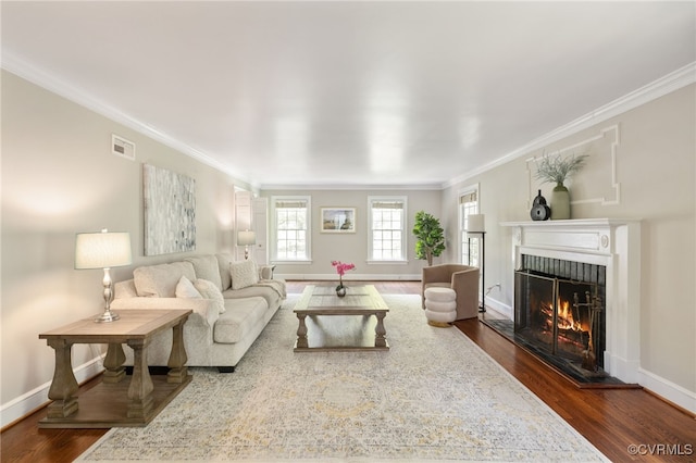 living area with ornamental molding, a fireplace, dark wood-style floors, and visible vents
