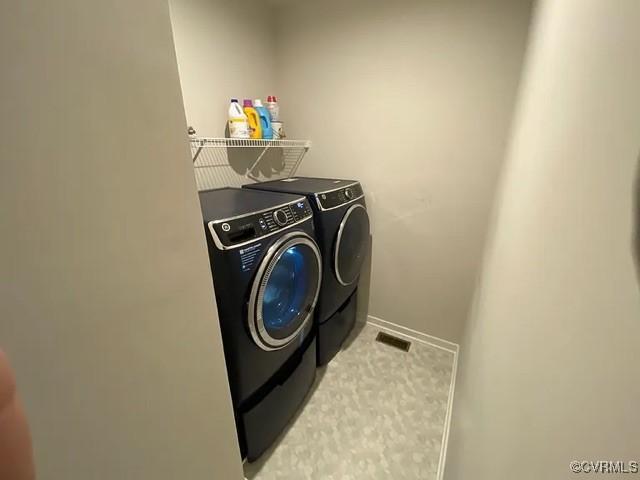 1900 Roseneath Rd Unit 4B, Richmond, VA 23230 - laundry area with laundry area, visible vents, baseboards, light carpet, and washer and dryer