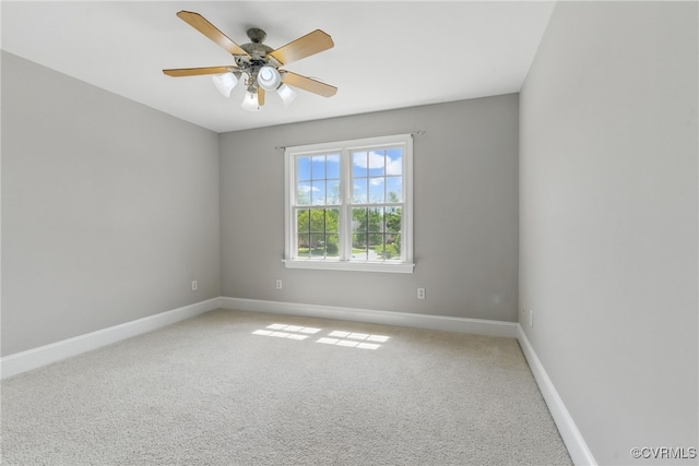 unfurnished room with light carpet, a ceiling fan, and baseboards