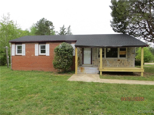 single story home featuring stone siding, a front yard, and covered porch