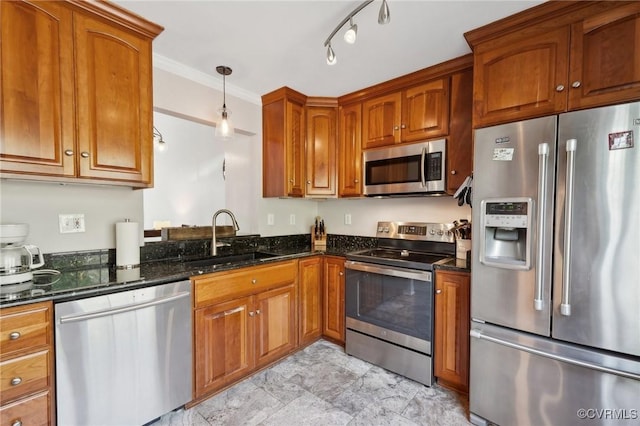 kitchen with a sink, brown cabinetry, and stainless steel appliances