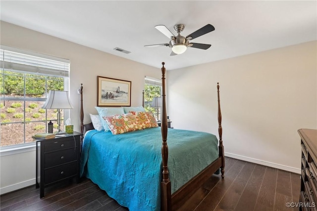 bedroom with baseboards, ceiling fan, dark wood-style flooring, and visible vents
