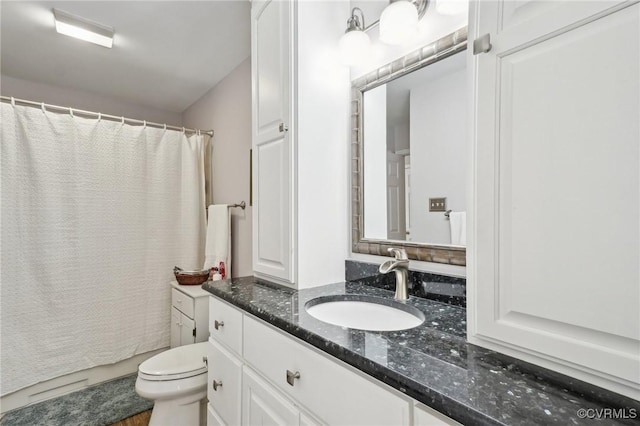 bathroom with toilet, a shower with shower curtain, and vanity