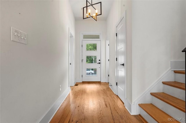 810 N 32nd St, Richmond, VA 23223 - doorway to outside featuring light wood-style flooring, a chandelier, stairs, and baseboards