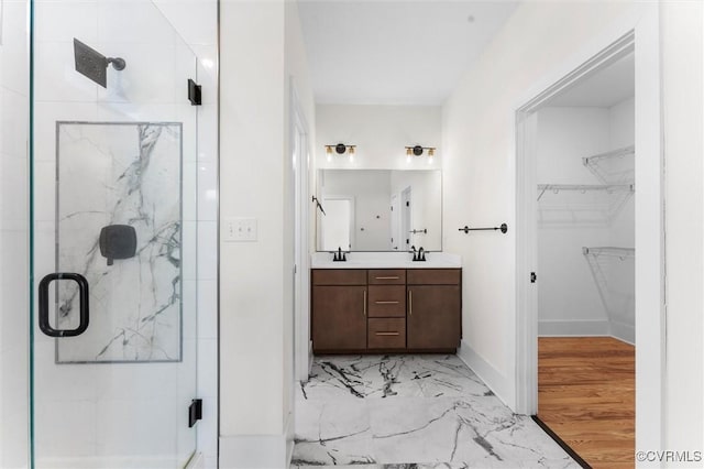810 N 32nd St, Richmond, VA 23223 - full bath featuring a marble finish shower, marble finish flooring, a spacious closet, double vanity, and baseboards