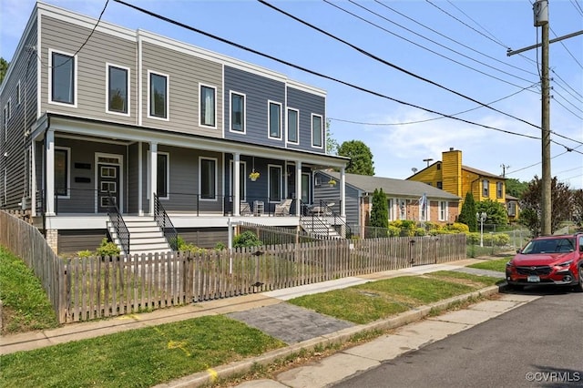 810 N 32nd St, Richmond, VA 23223 - view of property featuring covered porch, stairs, and a fenced front yard