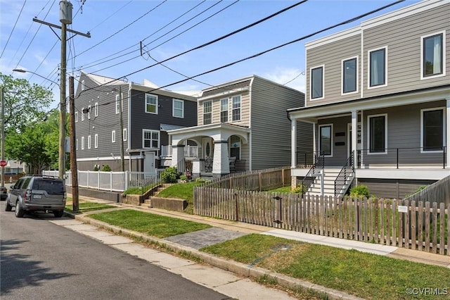 810 N 32nd St, Richmond, VA 23223 - view of front facade with covered porch and a fenced front yard