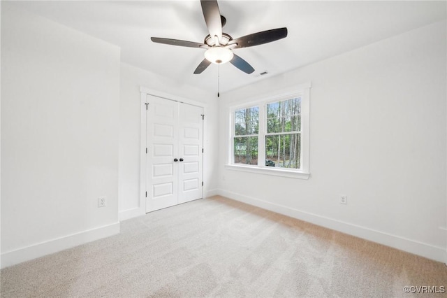 2355 Cedar Hill Rd, Mineral, VA 23117 - unfurnished bedroom with light colored carpet, baseboards, a ceiling fan, and a closet