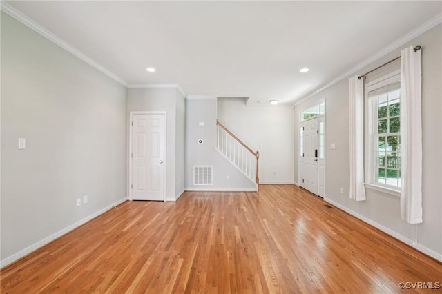 interior space with light wood finished floors, baseboards, visible vents, stairway, and ornamental molding