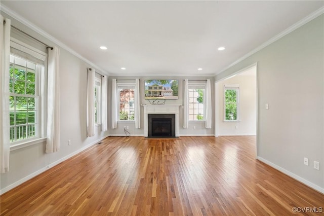 unfurnished living room featuring light wood finished floors and plenty of natural light