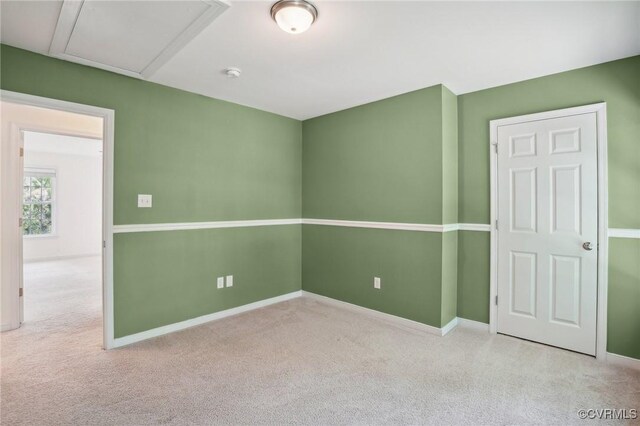 carpeted empty room with baseboards