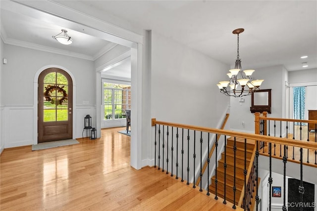 12712 Dell Hill Ct, Chesterfield, VA 23831 - foyer entrance with crown molding, wood finished floors, wainscoting, a chandelier, and arched walkways