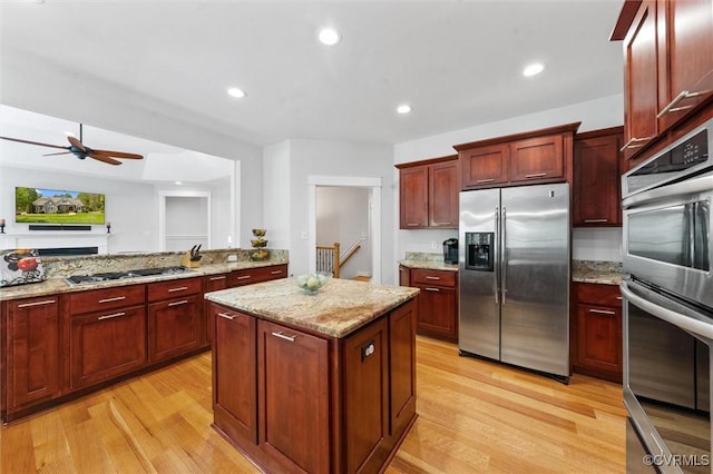 12712 Dell Hill Ct, Chesterfield, VA 23831 - kitchen with a center island, dark brown cabinets, light wood-style floors, a ceiling fan, and appliances with stainless steel finishes