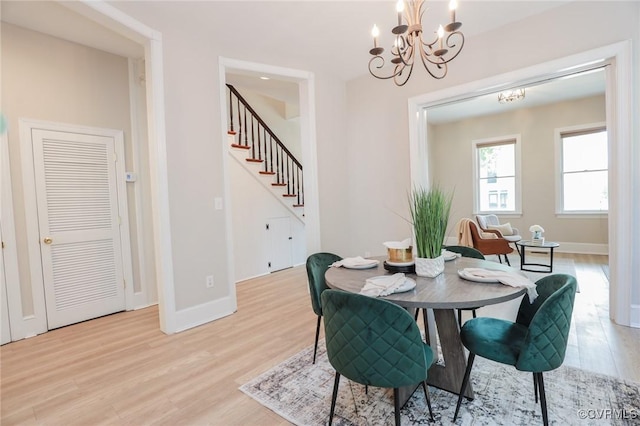 6 S Rowland St, Richmond, VA 23220 - dining area featuring light wood finished floors, baseboards, an inviting chandelier, and stairs