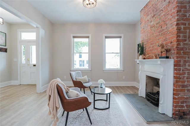 6 S Rowland St, Richmond, VA 23220 - living area with baseboards, wood finished floors, and a fireplace with raised hearth