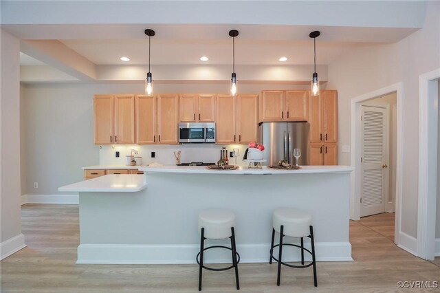 6 S Rowland St, Richmond, VA 23220 - kitchen with light countertops, light wood-style flooring, light brown cabinetry, and stainless steel appliances